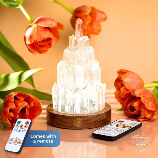 Crystal Quartz lamp with remote control on a wooden base, surrounded by flowers
