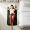 Woman relaxing on wellness mat